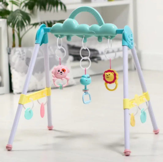 Colorful baby play gym with hanging toys on a light background